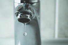 Water Drop Dripping From The Tap And Water Shortage