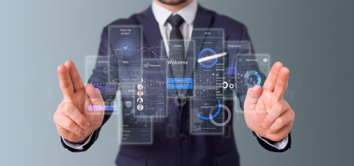 Poster - Businessman holding User interface screens with icon, stats and data 3d rendering