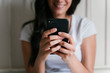 © Eva - unrecognizable caucasian woman on bed using mobile phone. Daytime and technology concept. Lifestyle indoors