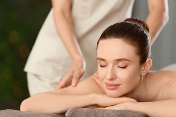 Wall Mural - Beautiful young woman enjoying massage in spa salon