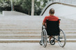 © joan - Thoughtful wheelchair man, can not climb the stairs has mobility problems.