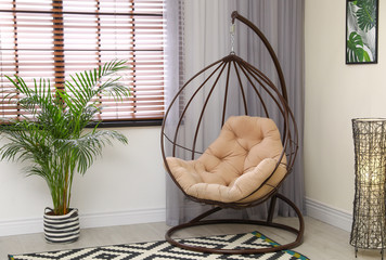 Poster - Comfortable swing chair with pillow in room interior