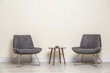 © New Africa - Room interior with modern chairs and table near light wall