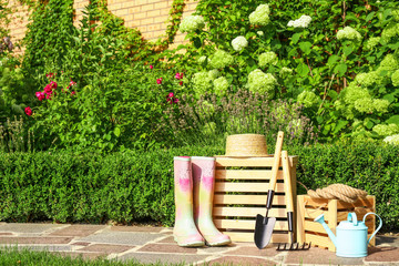 Wall Mural - Wooden crates and gardening tools on stone path at backyard