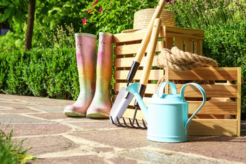 Wall Mural - Wooden crates and gardening tools on stone path at backyard