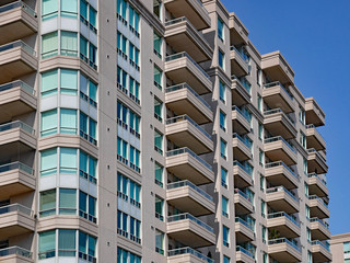 Canvas Print - modern apartment building with balconies and green tinted windows