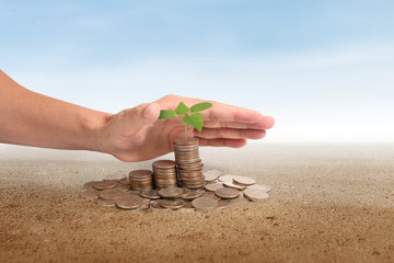 Coins stacked on each other in different positions,Man hand in business money