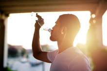 Attractive Athlete Sportsman Drinking Water After Training And Hydrating His Body.