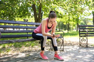 Sticker - Sporty young woman checking her pulse outdoors