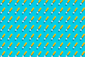 Yellow and white pills on blue background.