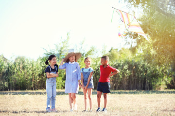 Poster - Little children flying kite outdoors