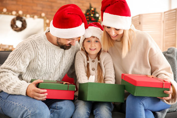 Wall Mural - Happy family with Christmas gifts at home