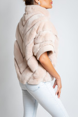 Wall Mural - Womens fur jacket, short sleeve, with a light pink tint.