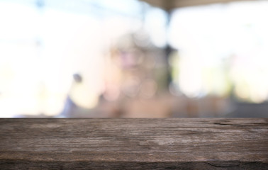 Empty dark wooden table in front of abstract blurred bokeh background of restaurant . can be used for display or montage your products.Mock up for space.