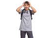 © valiza14 - Shocked teen boy in cap with headphones and backpack, isolated on white background. Surprised child puts his hands to head and looking at camera. Emotional portrait of teenager guy Back to school.