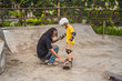 © galitskaya - Athletic boy learns to skateboard with a trainer in a skate park. Children education, sports
