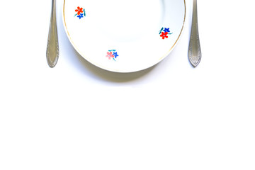 designer fragments of the served table for eating. Fork, spoon and plate - simple breakfast, lunch or dinner.