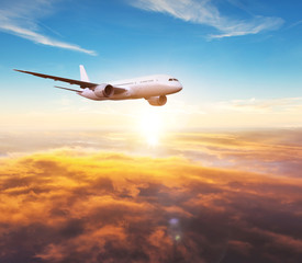 Wall Mural - passengers commercial airplane flying above clouds