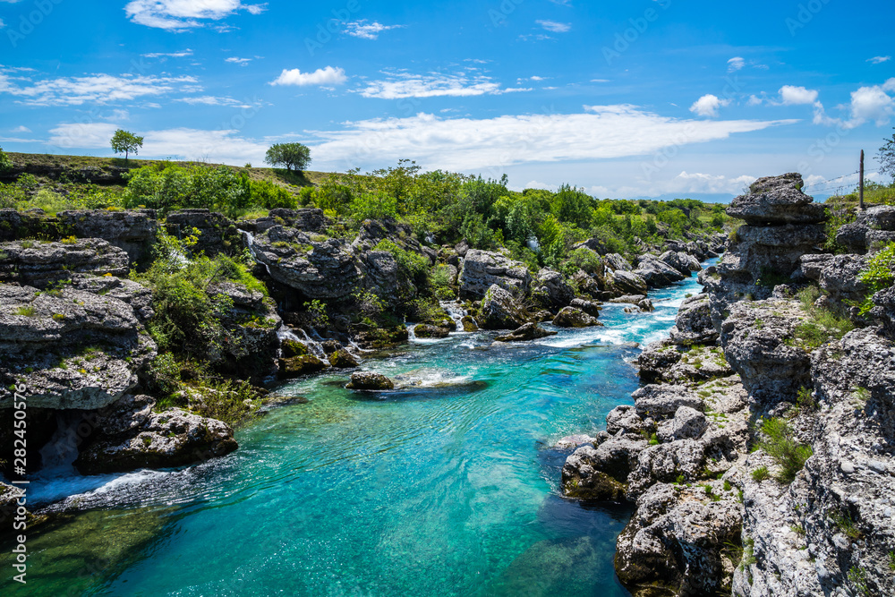 Obraz na płótnie Montenegro, Perfect clean crystal clear water of cijevna river in podgorica nature landscape near niagara falls on sunny day w salonie