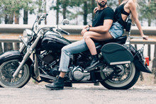 Cropped View Of Young Couple Of Bikers On Black Motorcycle On Road