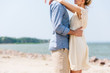 cropped view of romantic couple hugging at beach