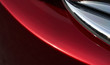 © jamesteohart - Close up detail of red metallic paint coating car body
