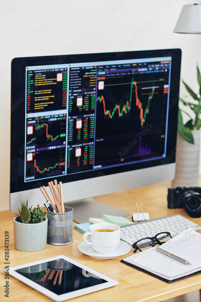 File Stock Computer Computer screen with stock market graphs, cup of green tea, tablet ...