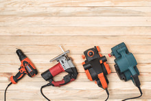 Set Of Hand Carpentry Power Tools For Woodworking Lies On A Light Wooden Background. Directly Above
