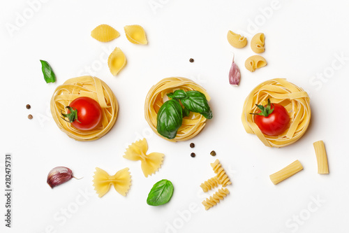 Cuadros en Lienzo Various uncooked pasta on white background