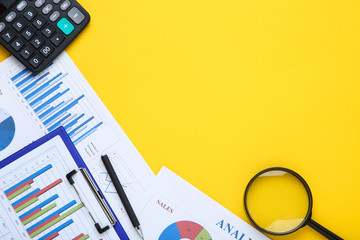 Poster - Financial papers with calculator, pen and magnifying glass on yellow background