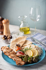 Wall Mural - assorted greek food platter with souvlaki, rice, pita and dolmades