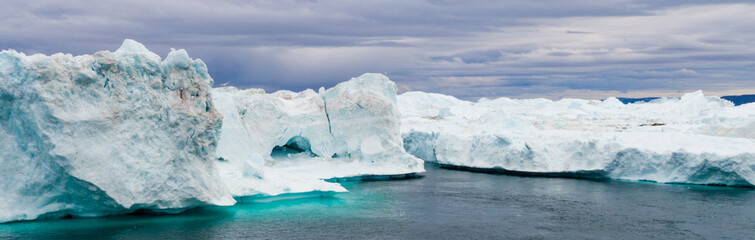 Wall Mural - greenland iceberg landscape of ilulissat icefjord with giant icebergs. icebergs from melting glacier