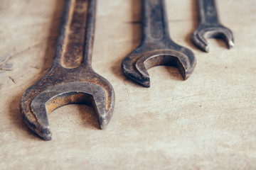 Different old wrenches on a wooden background and copy space. Top view