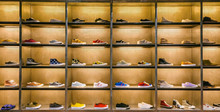 Lots Of Different Sneakers On The Showcase On Market. Image Of Sport Shoes On Shop-window