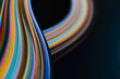 © fStop - Abstract rainbow paper wave pattern on black background