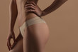 © Mirrorstudio - Thin young woman in underwear on beige background