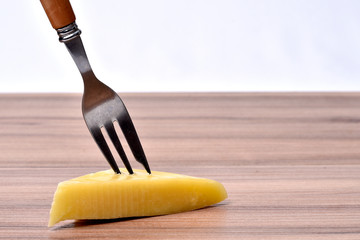 glass of alcoholic drink with cheese on the table on white background