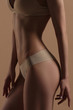 © Mirrorstudio - Thin young woman in underwear on beige background