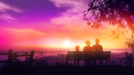 Wall Mural - Family of three on a bench at sunset and a beautiful view of the river