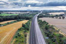 Aerial View Over Motorway Across Countryside Fields In UK