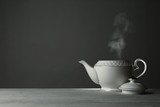 Fototapeta  - Ceramic teapot on table against grey background. Space for text