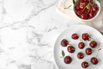 Poster - Plate of chocolate dipped cherries on white marble table, flat lay. Space for text