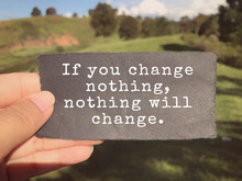 Motivational And Inspirational Wording - If You Change Nothing, Nothing Will Change Written On A Paper. Blurred Styled Background.