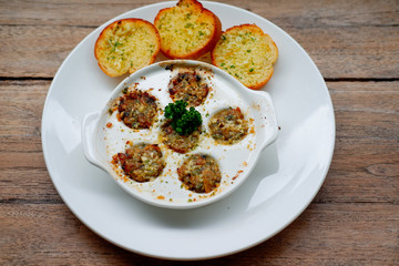 Poster - Baby Clam Escargot Style on wood table