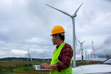 Wall Mural - Engineering windmill use the laptop checking windy