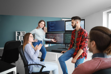 Wall Mural - Team of programmers working in office