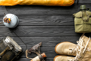 Set of items for camping on wooden background