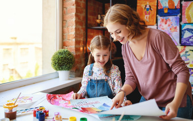 Wall Mural - mother and child daughter painting draws in creativity in kindergarten.