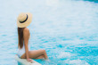 © siraphol - Portrait young asian woman happy smile relax around swimming pool in hotel resort