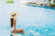 © siraphol - Portrait young asian woman happy smile relax around swimming pool in hotel resort